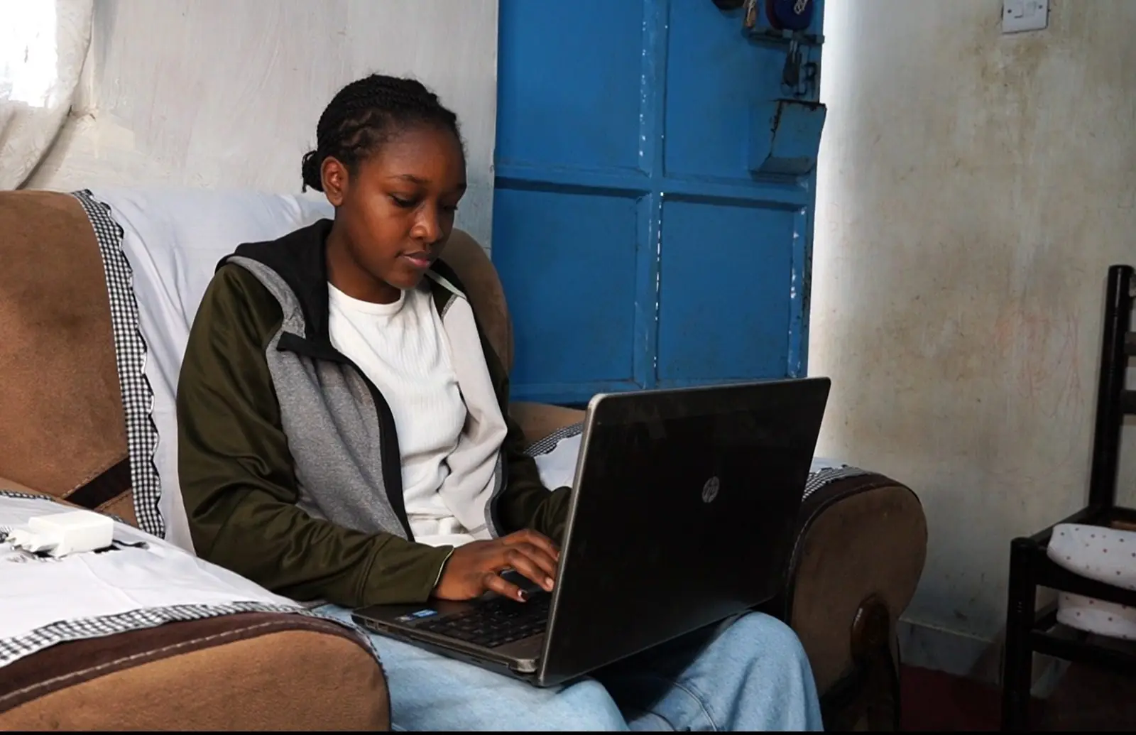 A young woman working on a laptop at home