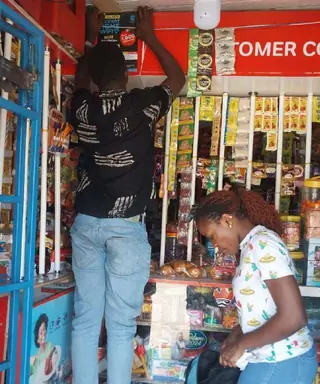 A konnekt technician installing Wi-Fi in a neighbourhood shop